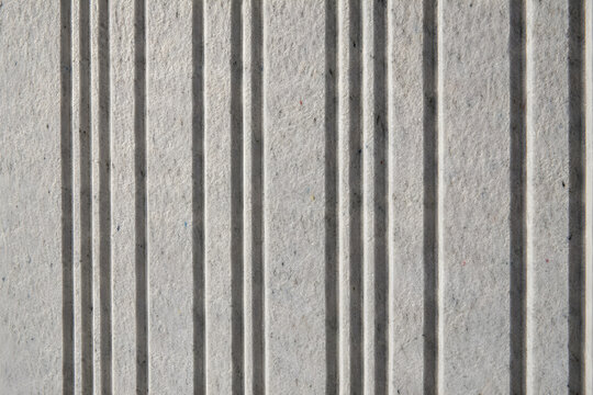 Macro view of a acoustic wall panel made from compressed recycled PET felt with geometric grooves