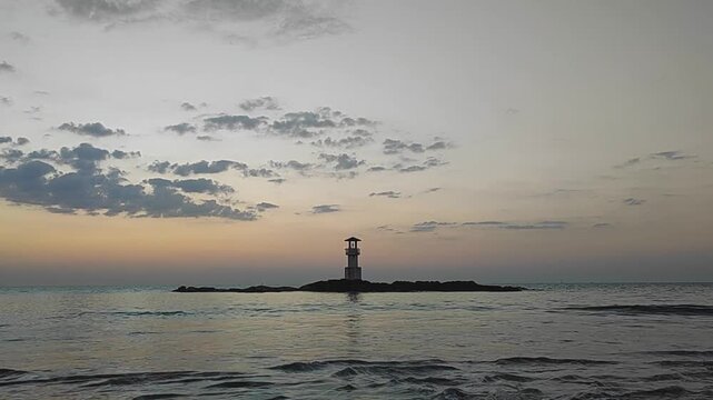 Silhouette  lighthouse with sunset and red twilight sky on the rock at Nang Thong Beach at Khao Lak Phang Nga Thailand - Seascape chill vibe on the beach - beautiful sky - Travel Landscape Thailand 