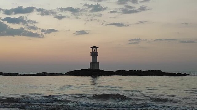 Silhouette  lighthouse with sunset and red twilight sky on the rock at Nang Thong Beach at Khao Lak Phang Nga Thailand - Seascape chill vibe on the beach - beautiful sky - Travel Landscape Thailand 