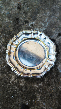 Vintage aesthetic silver plate on concrete background. Timeless aesthetic design template. Empty metal dish.