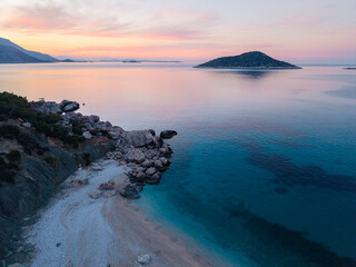 Fototapeta premium Serene twilight at Gerenlik Beach in Kas, Antalya, Turkey, with calm waters and distant islands