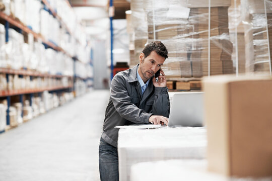 Phone call, shipping and laptop with man in warehouse for delivery, logistics schedule or update. Quality control, client feedback and courier depot with person and tech in factory for inventory
