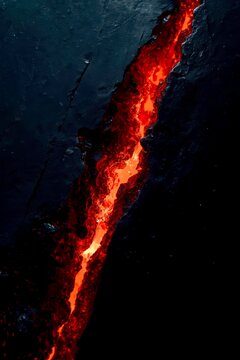 Lava flows bright orange through dark, jagged terrain