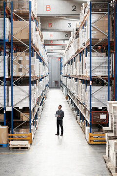 Man, warehouse or clipboard for logistics admin, inventory management or shipping quality control. High angle, employee and checklist for stock check, supply chain report or distributor info at depot