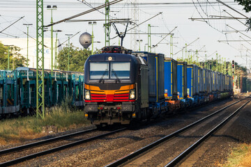Fototapeta premium Electric freight train hauling cargo