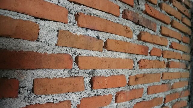 Authentic red brick wall with natural clay tones and gray mortar lines, Perfect for background texture overlays, architectural intros, urban design, motion graphics base layers, rustic or industrial 