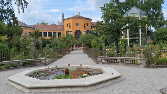 Renaissance garden section of the university botanical garden ("Orto Botanico") with St. Anthony basilica on the background in Padua, Veneto, Italy
