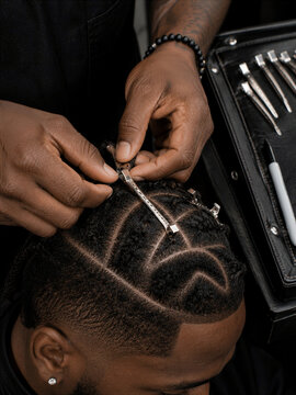 A hairstylist arranging hair extensions on braided hair