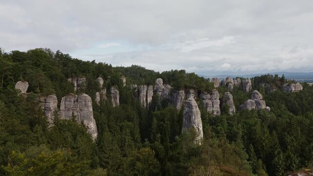 Panning shot of majestic sandstone rock formations in Hruba Skala rock town, Bohemian Paradise, Czech Republic