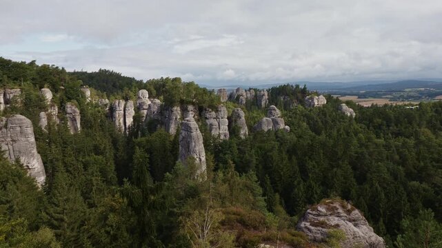Panning shot of majestic sandstone rock formations in Hruba Skala rock town, Bohemian Paradise, Czech Republic