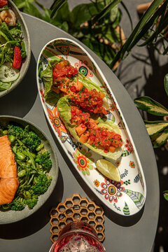 Fresh salmon ceviche served in lettuce boats with tropical fruit chili and lime