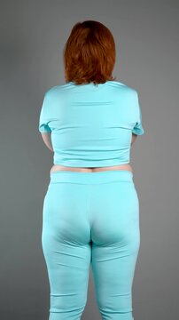 Unrecognizable curvy woman performs exercises for muscles of upper back, arms and buttocks, posture correction and physical therapy concept
