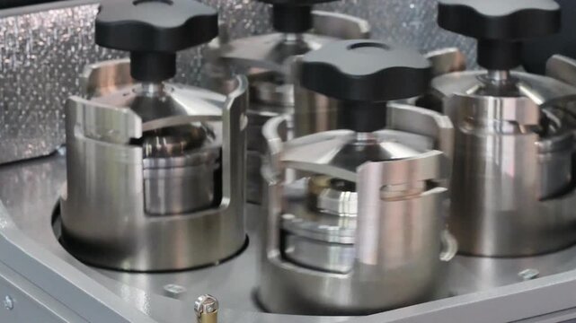 medical centrifuge with metal flasks spins and stirs liquid samples. Medical concept