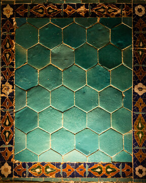 Historic green ceramic tile wall with traditional Islamic ornamental border background in Samarkand, Uzbekistan, decorative eid, ramadan or Qurban bayram background