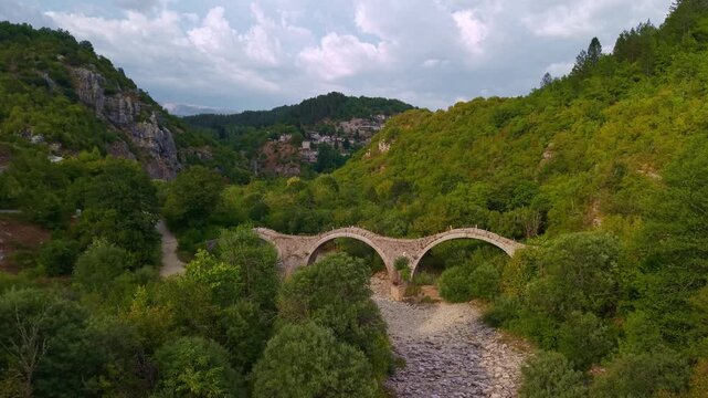 Aerial view of the Plakidas Three-Arched Stone Bridge in Zagori, Epirus, Greece