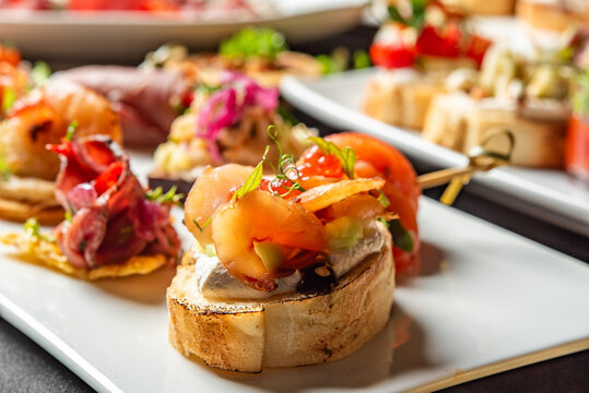 Delicious Spanish tapas and catering appetizers on white plates.