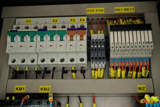Industrial electrical control cabinet with circuit breakers, relays, and terminal blocks
