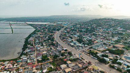 Fototapeta premium Accra Ghana Urban landscape with highway, buildings, and water bodies