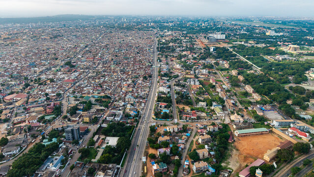 Aerial of Accra Ghana city infrastructure dividing dense residential areas and planned urban development