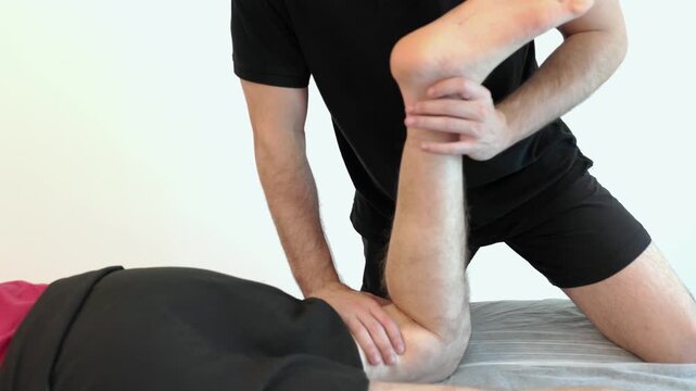 Physical therapist performing quadriceps stretching massage isolated on white background