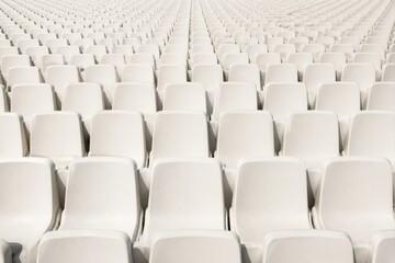 Fototapeta premium Empty stadium seats in bright rows of white seating