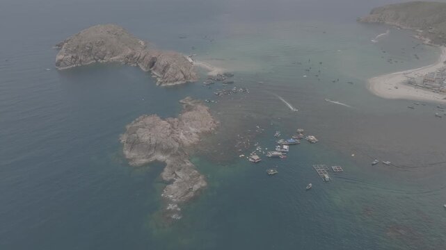 Aerial drone footage of kayaking over seaweed beds at Hon Kho, Gia Lai, Vietnam, featuring crystal-clear water, tropical coastline and an active outdoor adventure near Quy Nhon.