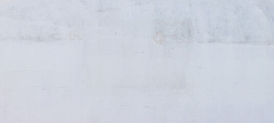 Obraz premium Minimalist off-white painted concrete wall background featuring subtle scratches, faint stains, and soft texture, providing a clean surface for graphic designs and overlays.