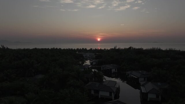 Aerial drone footage of sunrise over Bai Dai Beach, Cam Ranh, Khanh Hoa, Vietnam, featuring golden morning light, turquoise sea, white sand and a pristine tropical coastline.