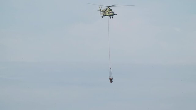 Helicopter mi8 passenger cargo aircraft flying high in sky during transit flight in 4K Ultra HD footage
