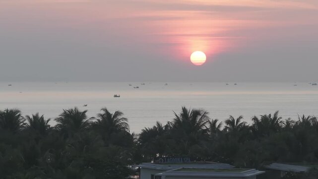 Aerial drone footage of sunrise over Bai Dai Beach, Cam Ranh, Khanh Hoa, Vietnam, featuring golden morning light, turquoise sea, white sand and a pristine tropical coastline.