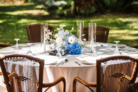 Festive table setting in the garden. Open-air restaurant.
