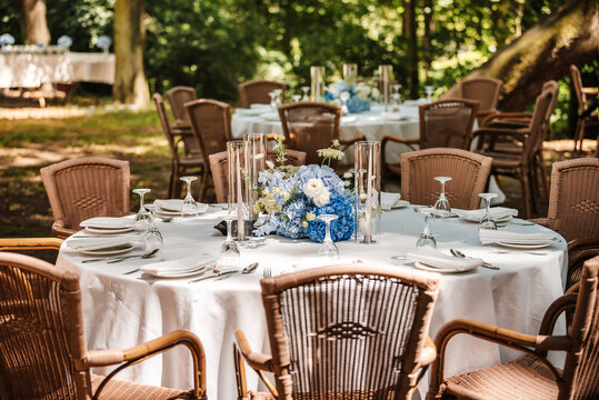 Festive table setting in the garden. Open-air restaurant.