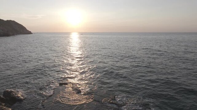 Aerial drone footage of sunrise at Hang Rai, Khanh Hoa, Vietnam, featuring dramatic rocky coastline, turquoise sea, coral reef, golden morning light and breathtaking coastal landscape.