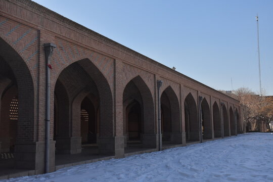 Historic brick arcade and pointed arches at the Blue Mosque complex in Tabriz, Iran