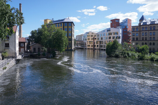 Scenic view of a river running through an industrial city landscape