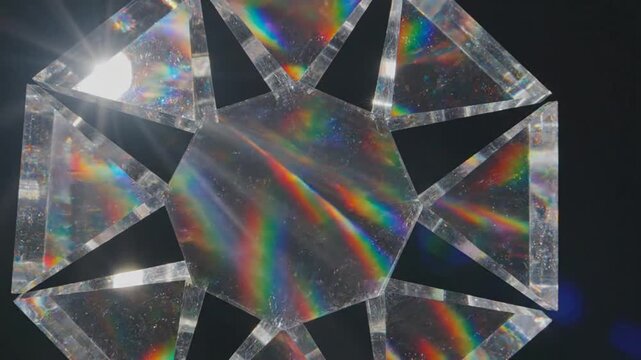 Prismatic Reflections: Geometric crystal prisms refract light, creating a mesmerizing spectrum of rainbow colors against a dark background, highlighting the science of light and optics.