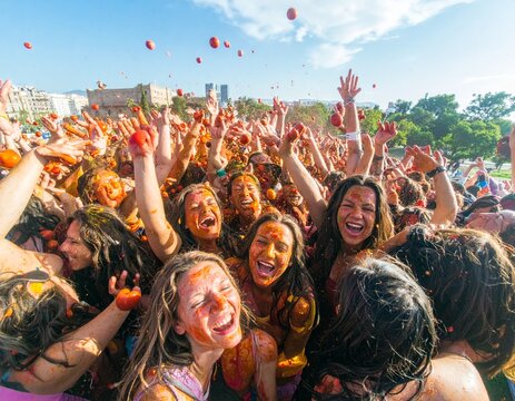 Festival participants enjoying the vibrant atmosphere of La Tomatina in the streets of Bu&ntilde;ol, Spain.