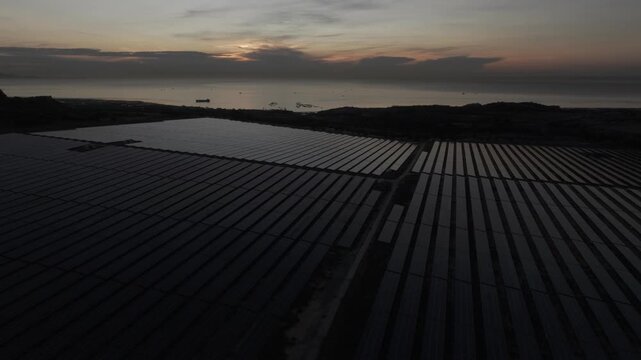 Aerial drone footage of Phuoc Dinh Solar Farm in Khanh Hoa, Vietnam, featuring vast photovoltaic panels, showcasing renewable energy, clean power infrastructure and sustainable technology.
