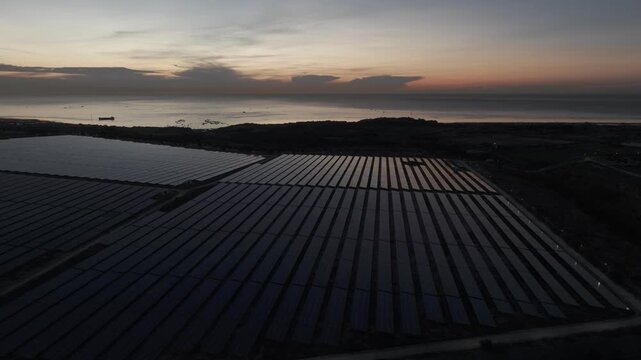 Aerial drone footage of Phuoc Dinh Solar Farm in Khanh Hoa, Vietnam, featuring vast photovoltaic panels, showcasing renewable energy, clean power infrastructure and sustainable technology.