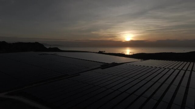 Aerial drone footage of Phuoc Dinh Solar Farm in Khanh Hoa, Vietnam, featuring vast photovoltaic panels, showcasing renewable energy, clean power infrastructure and sustainable technology.