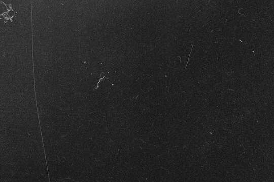 Clean Film Grain Texture Overlay with Subtle Dust Scratches on Black Background for Cinematic Photo Effect