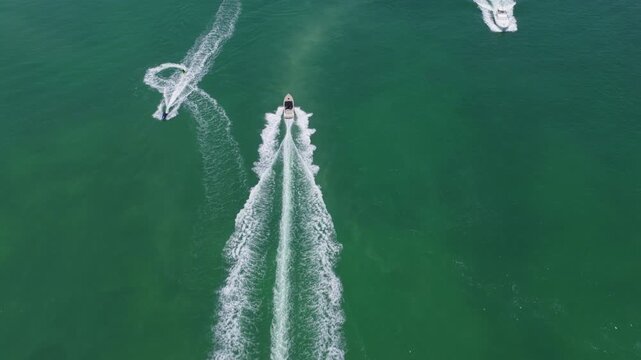 Vacation on summertime. Aerial view at vacation. Jet ski in motion. Summer vacation activity. Water sport activity in summer. Sea beach lifestyle. Beach life concept