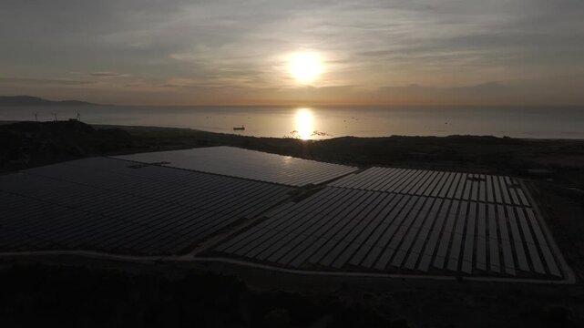Aerial drone footage of Phuoc Dinh Solar Farm in Khanh Hoa, Vietnam, featuring vast photovoltaic panels, showcasing renewable energy, clean power infrastructure and sustainable technology.