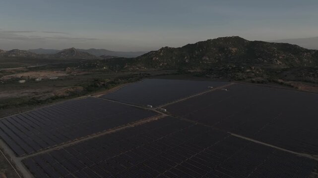 Aerial drone footage of Phuoc Dinh Solar Farm in Khanh Hoa, Vietnam, featuring vast photovoltaic panels, showcasing renewable energy, clean power infrastructure and sustainable technology.