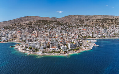 Fototapeta premium Aerial view of downtown district of Saranda, Albania. Sarandë is a coastal city on the Ionian Sea and the unofficial capital of the Albanian Riviera. 