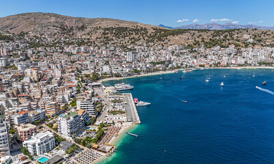Fototapeta premium Aerial view of downtown district of Saranda, Albania. Sarandë is a coastal city on the Ionian Sea and the unofficial capital of the Albanian Riviera. 