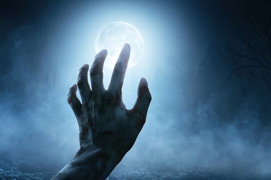 Creepy Zombie Hand Rising from Ground in Foggy Night Horror Halloween Background