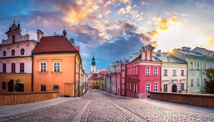 historic colorful houses and stone walkway in lublin poland overlooking the old town architecture under a cloudy sky © Reginald