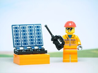 Fototapeta premium Indonesia - August 24, 2023 : Mini toy at outdoor with blurred background. Solar Cell concept design.
