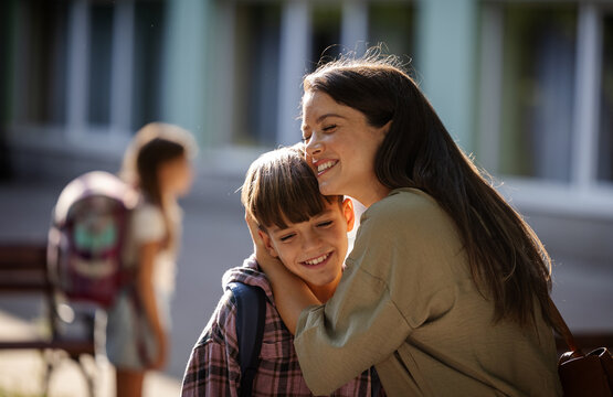 Mother and son share a moment outside a school